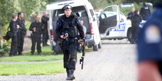 Armed police cordoned off streets as Armed Offenders Squad went to a house in Carroll St. Photo / Duncan Brown