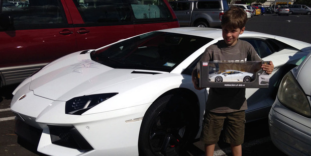 Alex Faulkner, 9, with a white Lamborghini outside Lynn Mall. Photo / Supplied