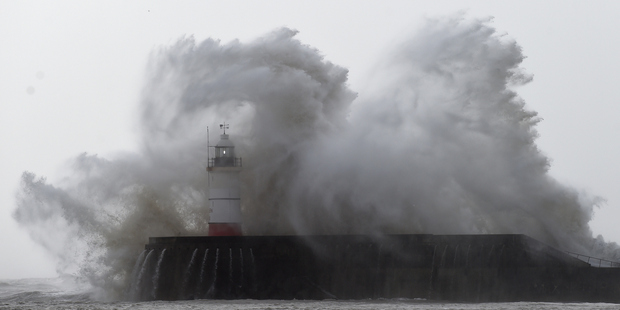 Newhaven Harbour wall and lighthouse take a battering. Photo / Getty Images