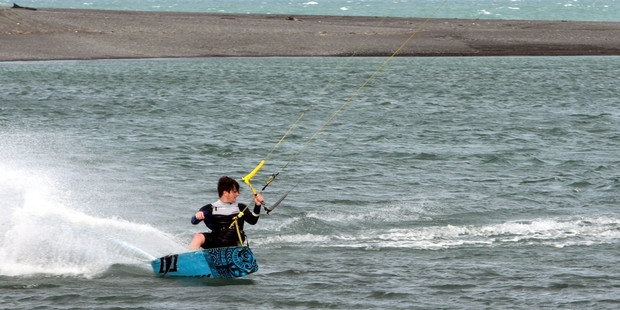 A kite surfer enjoys the windy weather conditions at the Waitangi basin near Napier. Photo / Paul Taylor