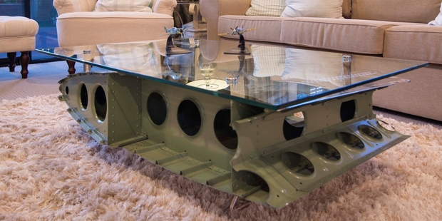 A coffee table, made from the tail section of a 1953 de Havilland Heron, sits in the entrance of Classic Flyers.
