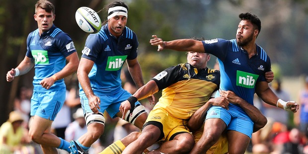 George Moala offloads during the Super Rugby pre-season match against the Hurricanes. Photo / Getty