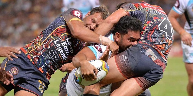 Konrad Hurrell of the World All Stars fights through the defence to score a try during the NRL match between the Indigenous All-Stars and the World All-Stars. Photo / Getty Images.