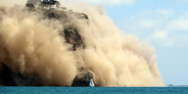 Godley Head on Banks Peninsula wreathed in dust after the 5.7 earthquake. Photo / Andy Winneke