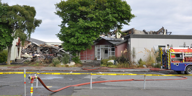 The remains of the gutted hall, administration block and staff room section of Westland High School. Photo / Hokitika Guardian