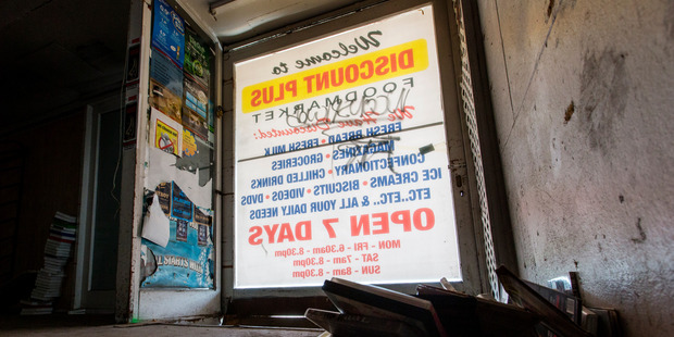 "Open 7 Days" signs remain standing despite shops long having closed. Photo / Mike Scott