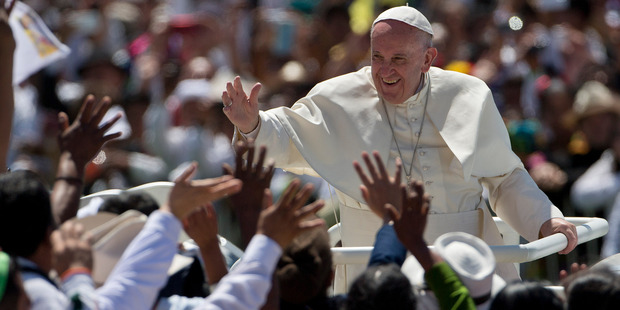 Pope Francis waves to the crowd as he leaves after celebrating Mass in San Cristobal de las Casas, Mexico. Photo / AP
