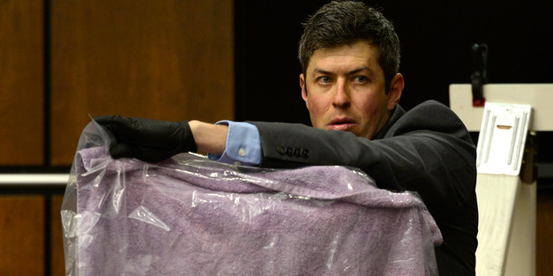 Longmont Det. Mark Deaton holds up evidence. Photo / AP