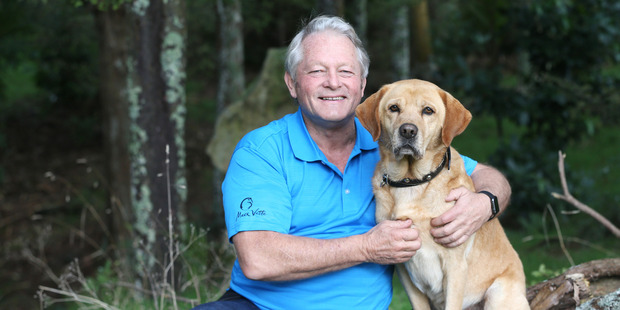 Animal trainer Mark Vette, hugging his dog, Paddy, is attempting to teach man's best friend to pilot a plane. Photo / Doug Sherring