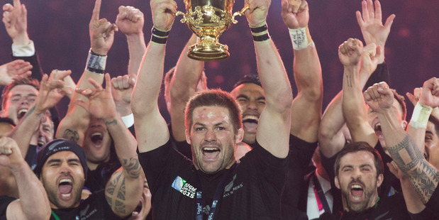 Richie McCaw holds aloft the Webb Ellis Trophy. Photo / Brett Phibbs