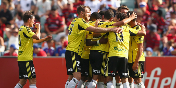 Blake Powell of the Phoenix celebrates with team mates after scoring a third goal during the round 19 A-League match against the Western Sydney Wanderers. Photo / Getty Images.