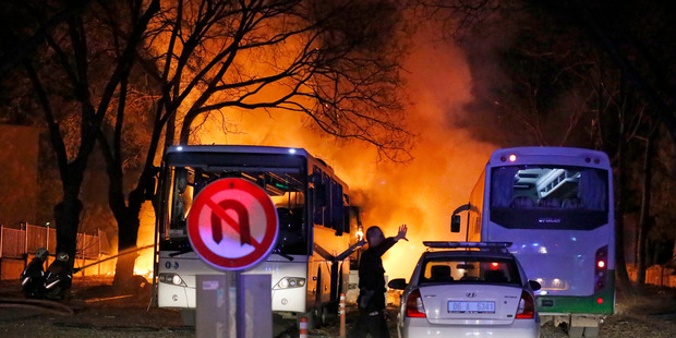 A police officer clears the area of the explosion in Ankara. Photo / AP