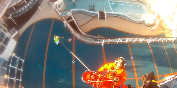 RESCUE: A woman who suffered a heart attack is winched off a cruise ship near the Three Kings Islands into the Northland Electricity helicopter and flown to Auckland.PHOTOS/NEST