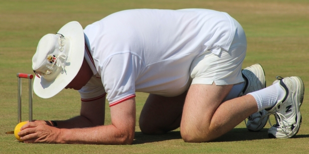 Vince Neil, from the Rose Gardens Croquet Club in Palmerston North, was the tournament referee. He's seen here checking the precise settings during the finals of the national men's championships.
