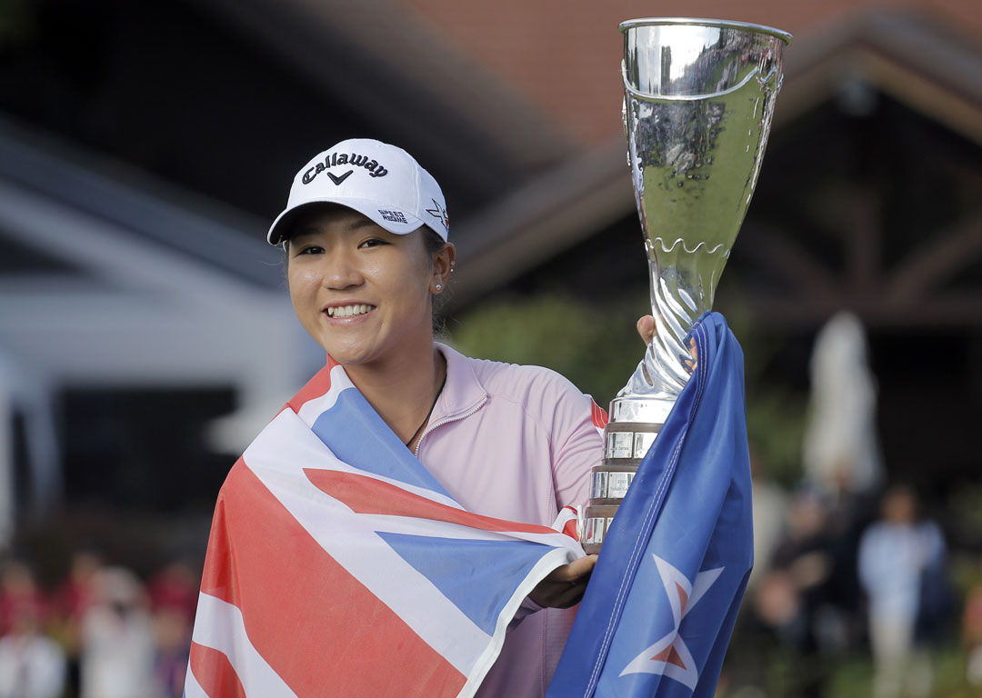 Lydia Ko celebrates with her trophy after winning the Evian Championship. Photo / AP