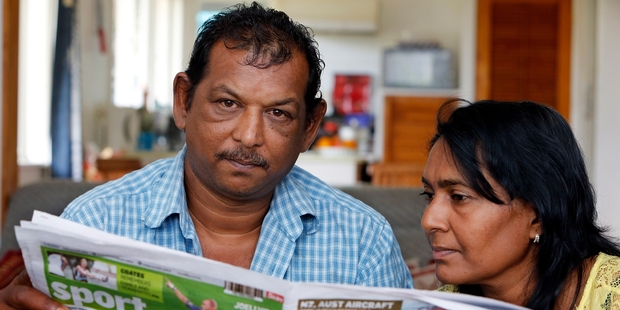 Rabendra Prasad and wife Suzy catch up with Fiji news through a Fijian newspaper. Photo / John Stone