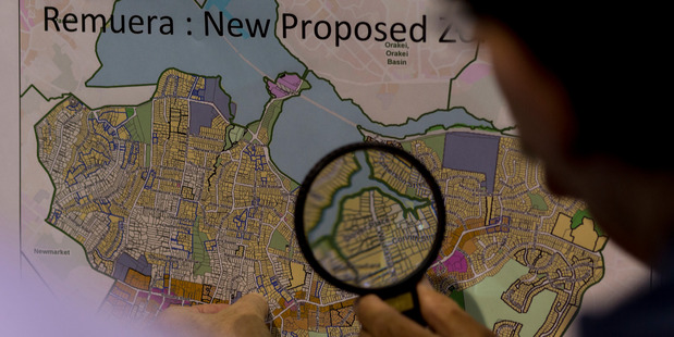 An eastern suburbs resident studies a map of proposed housing density changes. Photo / Dean Purcell