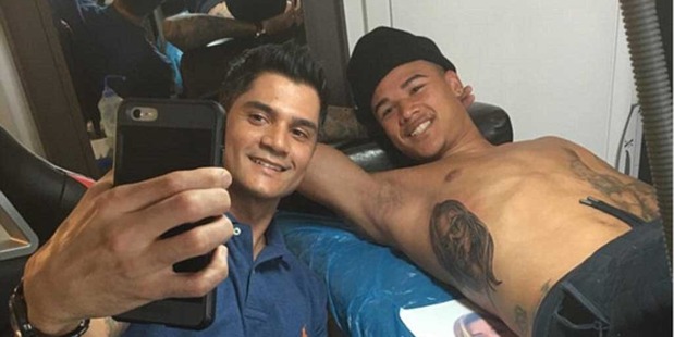 Kenedy smiled for the camera as uploaded this picture having just had his girlfriend tattooed on his side. Photo / Instagram.