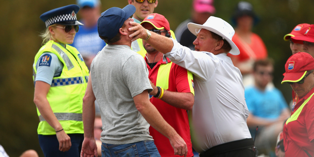 Security detain a spectator during day four of the test at Hagley Oval. Photo / Getty