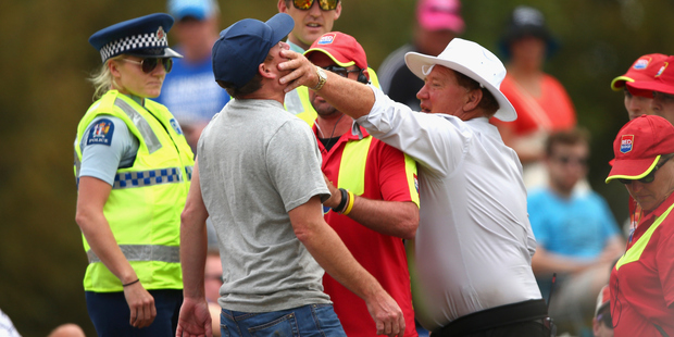 Security detain a spectator during day four of the test at Hagley Oval. Photo / Getty