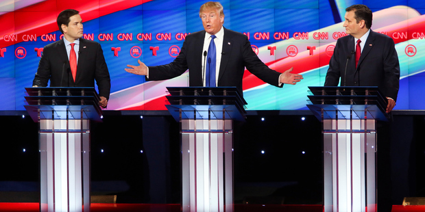 Republican presidential candidates Sen. Marco Rubio (L) and Ted Cruz (R) listen as Donald Trump answers a question. Photo / Getty