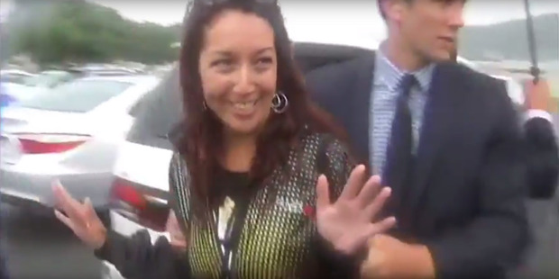 Josie Butler is apprehended after she threw a pink dildo at Cabinet minister Steven Joyce and hit him in the face. Photo / Supplied