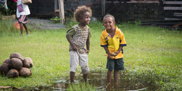 Kids playing in a puddle. Photo / Getty Images