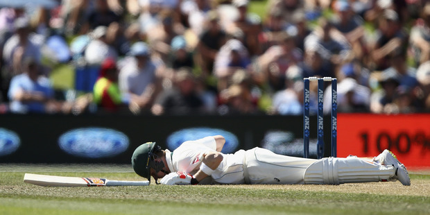 Australian captain Steve Smith sprawls on the pitch after being hit by a ball from New Zealand bowler Neil Wagner. Photo / Getty Images