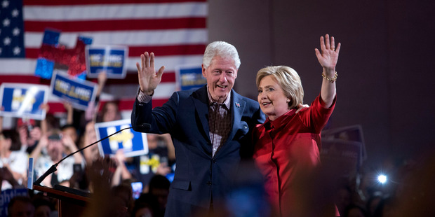 Former President Bill Clinton and Democratic presidential candidate Hillary Clinton wave after Hillary Clinton's victory speech for the Nevada caucuses. Photo / AP