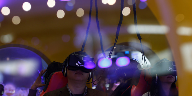 A man uses virtual reality glasses during the Mobile World Congress wireless show. Photo / AP