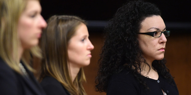 Defense attorneys stand with Dynel Lane as she is found found guilty of attempted first-degree murder, assault and unlawful termination of a pregnancy. Photo / AP