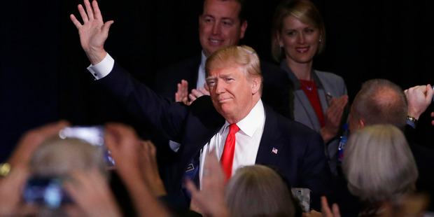 Donald Trump waves as he walks up to the podium during a rally. Photo / AP