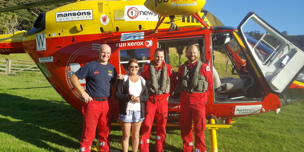 Leanne Turner with the Auckland Rescue Helicopter Trust crew after they arrived on Urupukapuka Island. PHOTO/supplied