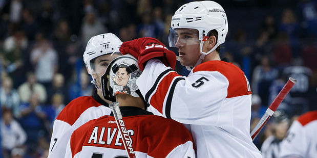 Emergency backup goalie Jorge Alves of the Carolina Hurricanes is congratulated on his NHL debut by teammates. Photo / Getty