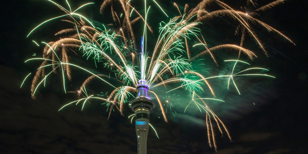 Fireworks light the sky around Auckland's Skytower to see in the 2017 New Year. Photo / Peter Meecham