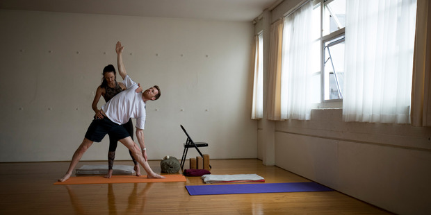 Canvas reporter Greg Bruce gets instruction from yoga teacher Jude Hynes. Photo / Dean Purcell