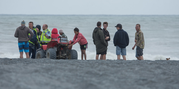 Searchers at Onoke spit. Photo / Wairarapa Times-Age