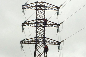 Transpower workers replace insulators on one of the damaged pylons. PHOTO / TRANSPOWER