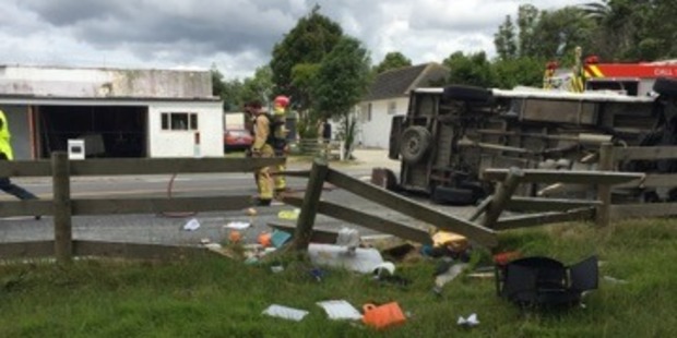 Firefighters at the scene of a crash between a car and a campervan which injured seven people, including two young children. Photo / Supplied