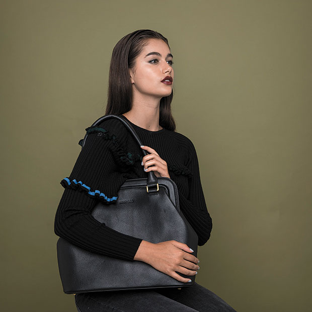 Maia carries a Harry & Co 'Margo' handbag, $575; and wears a Wynn Hamlyn knit top, $440.