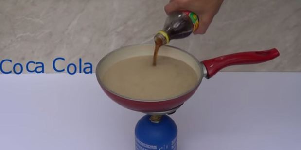 Home Science began by boiling a pan full of Coke. Photo / YouTube, Home Science