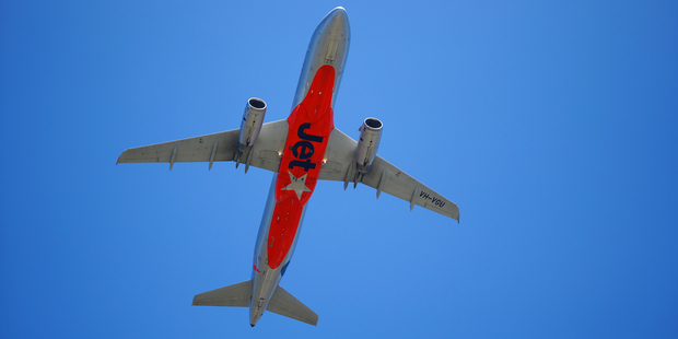 A Jetstar plane flies over Sydney. Photo / Getty