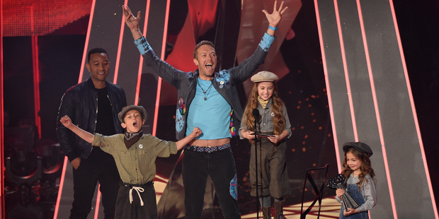 Chris Martin, of Coldplay reacts as child performers read an acceptance speech on behalf of Coldplay. Photo / AP