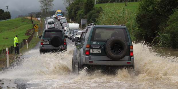 Traffic backed up for half a kilometre in both directions after the bottom of Bulls Gorge flooded, on State Highway 10 south of Kerikeri. Photo / Peter de Graaf