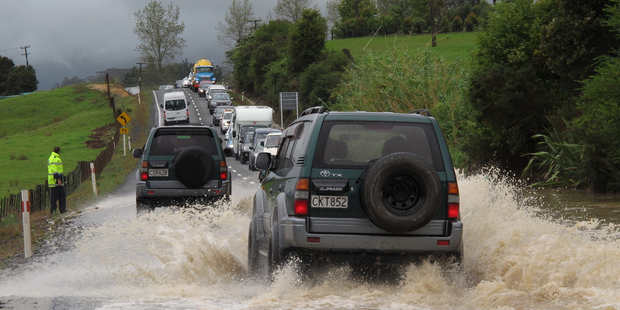 Traffic backed up for half a kilometre in both directions after the bottom of Bulls Gorge flooded, on State Highway 10 south of Kerikeri today. Photo/Peter de Graaf