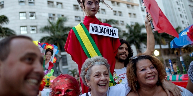 Brazilians, saddled with a sickly economy, carry an effigy of impeached President Dilma Roussef. Photo / AP