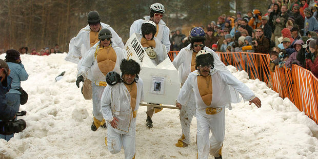 Festivities began with a parade of a dozen hearses, followed by a 'coffin race'. Photo / Getty Images