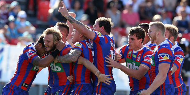 Nathan Ross of the Knights celebrates his try with teammates. Photo / Getty