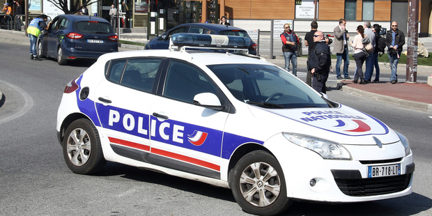 A police car blocks a road after an attack in a high school in Grasse, southern France. Photo / AP