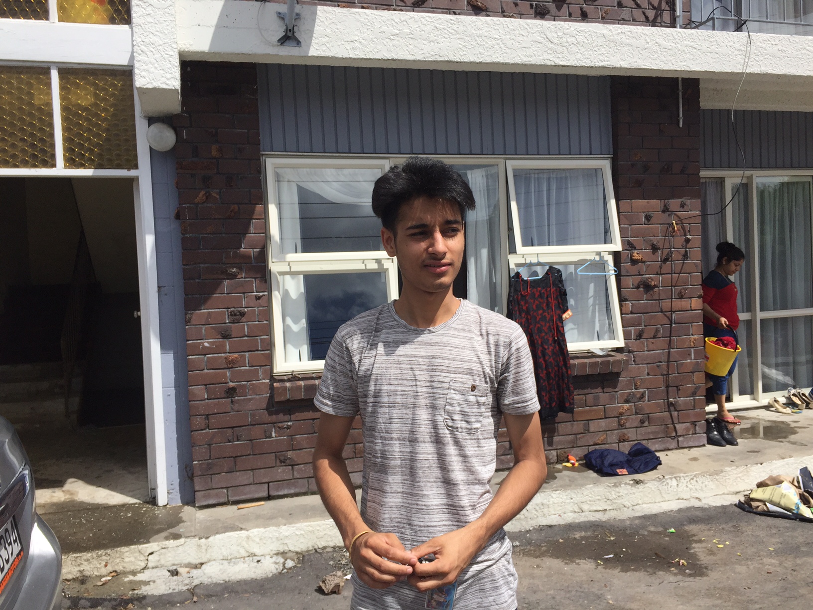 Gurvinder Singh, 20, stands outside the flooded apartments on Great North Road, Kelston. Photo / Vaimoana Tapaleao